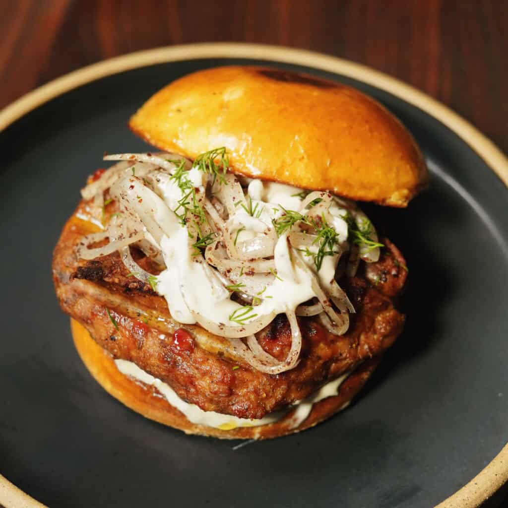 Shawarma-Spiced Chicken Burgers with Sumac Onions & Tahini Yogurt