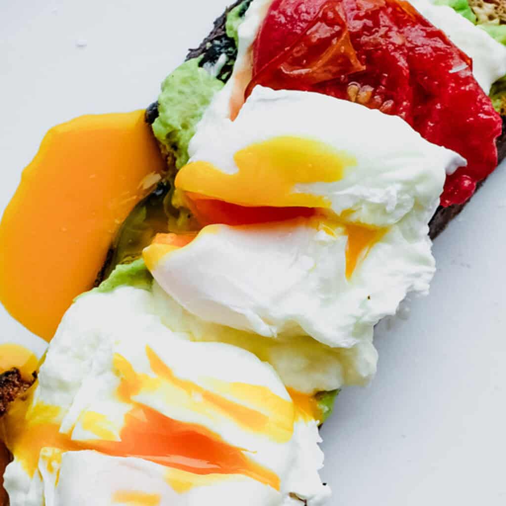 Avocado Toast w/ Poached Egg, Whipped Burrata, & Tomato Confit