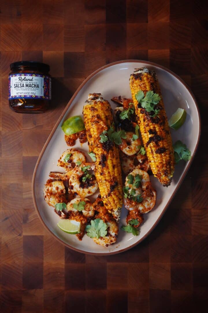 Grilled shrimp glazed in Roland Foods Salsa Macha, served with grilled corn brushed in macha mayo