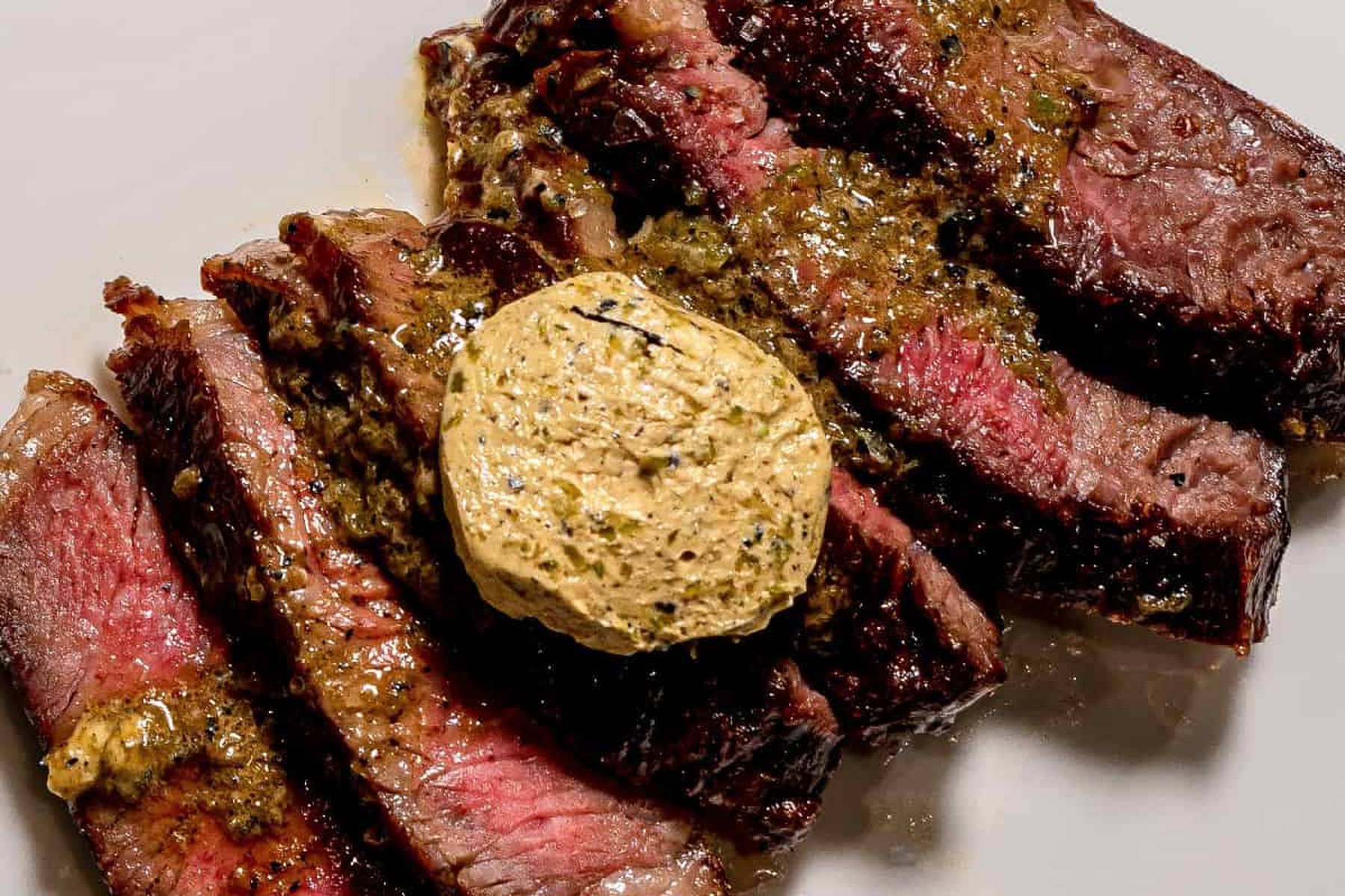 A sliced ribeye topped with a puck of miso butter, basted in the pan as it seared.
