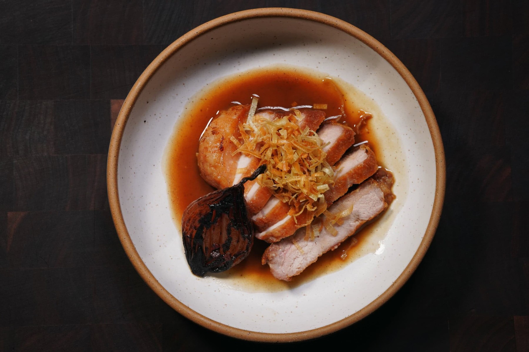 Sliced pork in a glossy bordelaise built from the fond lifted off the bottom of the pan.
