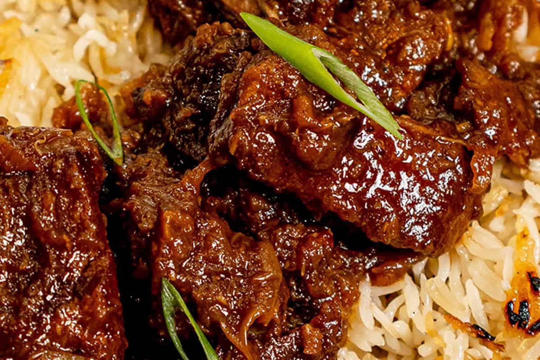 Braised pork shoulder over rice, cooked at a bare simmer until it falls apart.